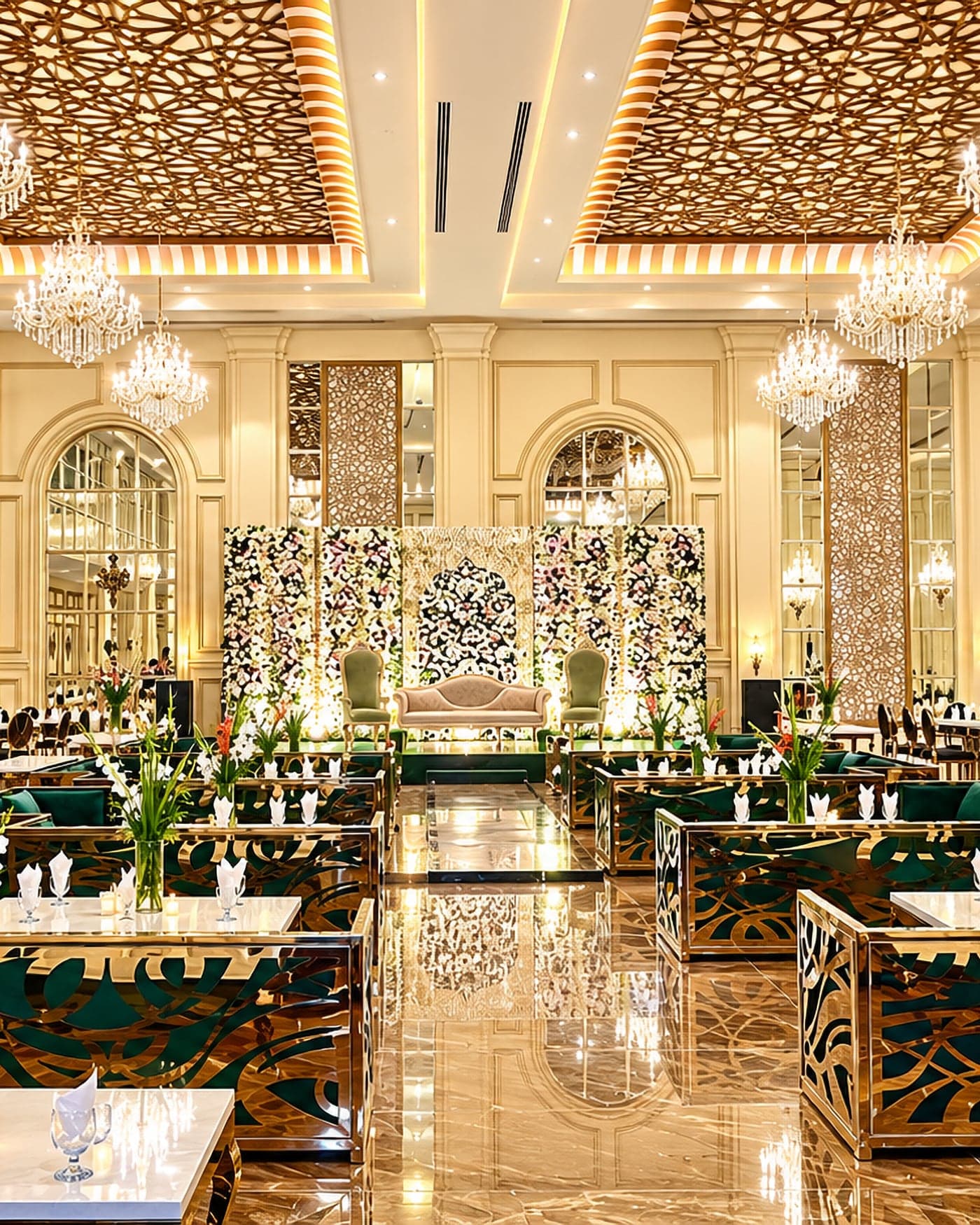The banquet hall at Faletti’s Banquet Divine Garden, chandeliers above green velvet seating